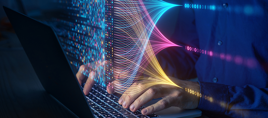 man typing on laptop with vibrant data